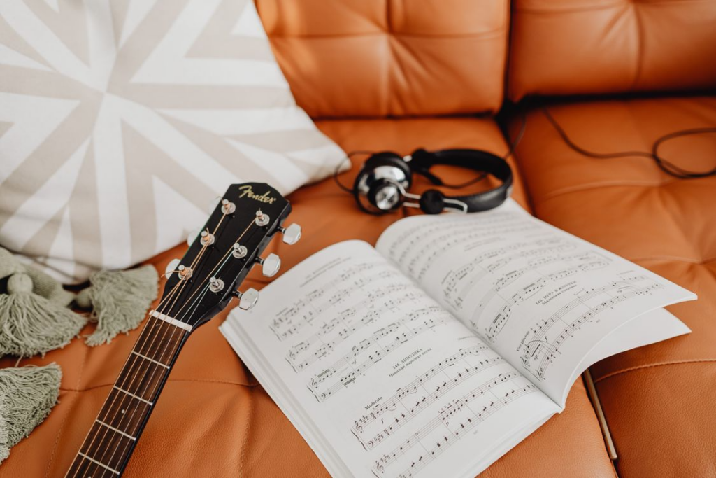 Notebook and earphones used to study foreign-language songs.